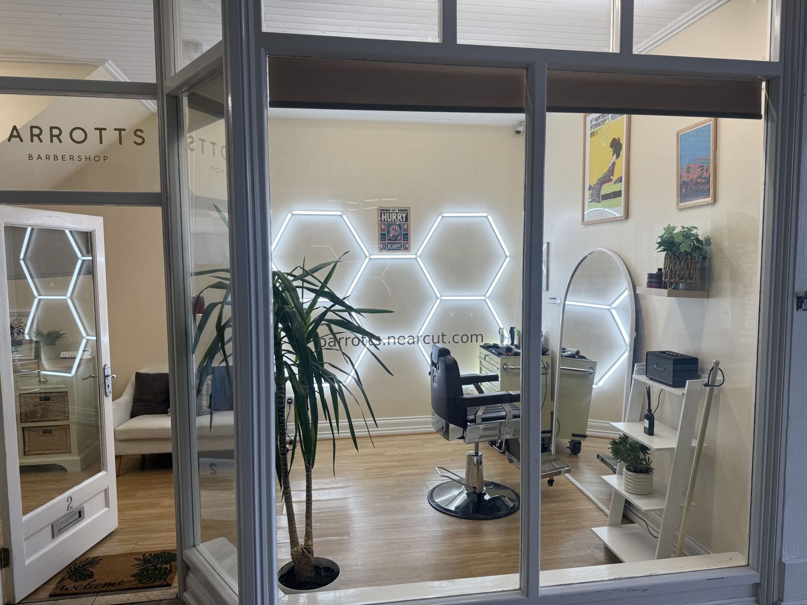 Looking through the PARROTTS BARBERSHOP window into the shop